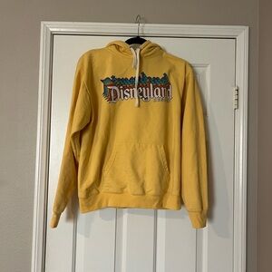 GUC Disneyland yellow hoodie size Medium. Front pocket. Cotton/poly combo.